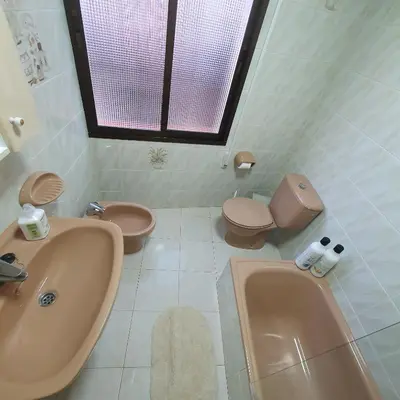 a bathroom with a sink and a toilet and a tub at Casa Central in Cullera