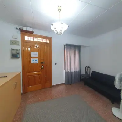a living room with a couch and a wooden door at Casa Central in Cullera