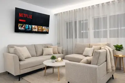 a living room with a couch and a table at Avakian Suite Valencia in Valencia