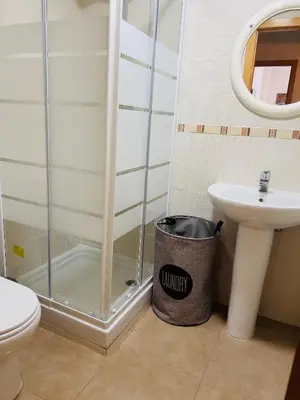 a bathroom with a shower and a trash can at ISABEL Apartment in Puerto de Sagunto