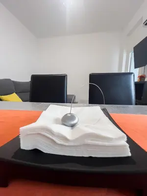 a table with a white napkin on top of it at Mar y Puerto in Puerto de Sagunto