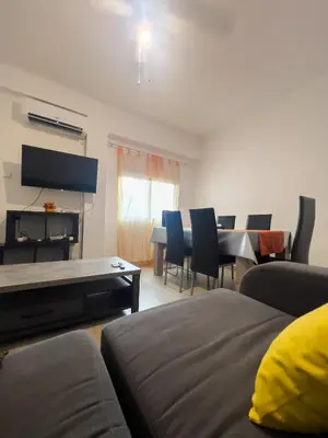 a living room with a couch and a table and chairs at Mar y Puerto in Puerto de Sagunto