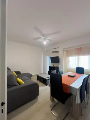 a living room with a table and a couch at Mar y Puerto in Puerto de Sagunto