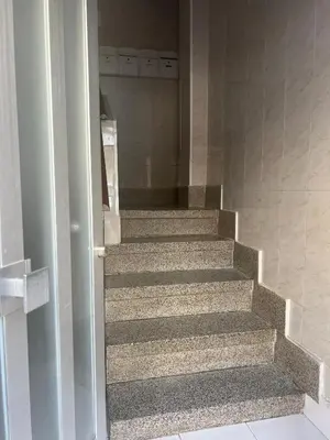 a stairway in a building with a door open at Mar y Puerto in Puerto de Sagunto