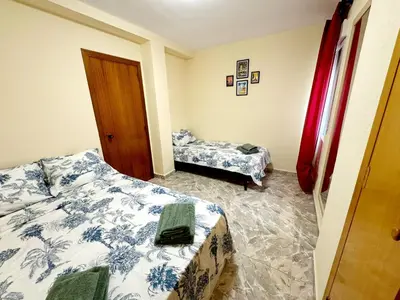 a room with two beds in a room with a bedictericter at Cozy Flat with City & Beach in Puerto de Sagunto