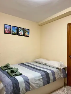 a bedroom with a bed with three pictures on the wall at Cozy Flat with City & Beach in Puerto de Sagunto