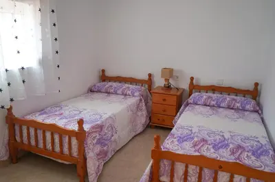 a bedroom with two twin beds and a dresser at casa imperial in Tous