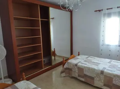 a bedroom with a bed and a large window at casa imperial in Tous