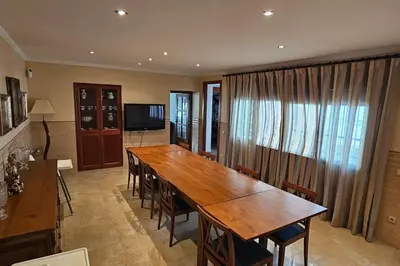 a dining room with a large wooden table and chairs at casa imperial in Tous