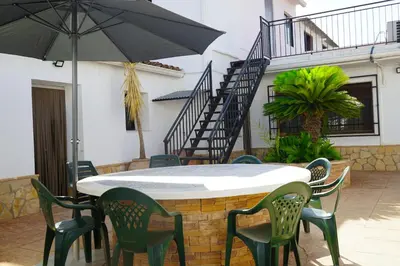 a table and chairs with an umbrella on a patio at casa imperial in Tous