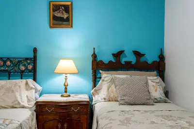 a blue bedroom with two beds and a lamp at Mirador 5 del Mercado Central - habitacion con baño privado en el centro de la Ciudad Vella in Valencia
