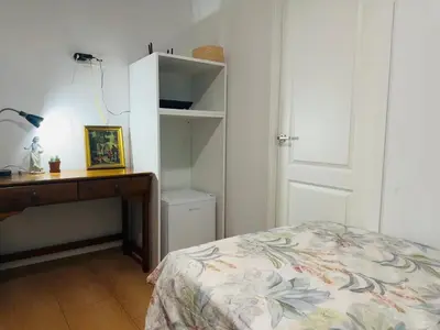 a bedroom with a bed and a desk and a door at Mirador 5 del Mercado Central - habitacion con baño privado en el centro de la Ciudad Vella in Valencia