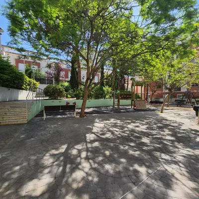 a park with a tree and a bench at MD Malva Valterna in Paterna