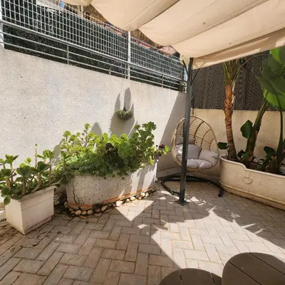 a patio with potted plants and a tent at MD Malva Valterna in Paterna