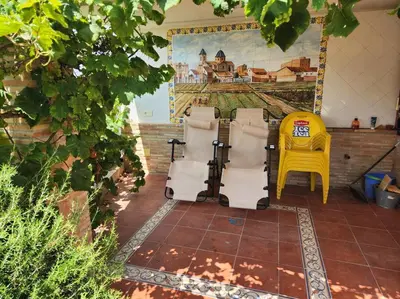 a group of chairs and a yellow chair at Casa Villa Molins in Valencia