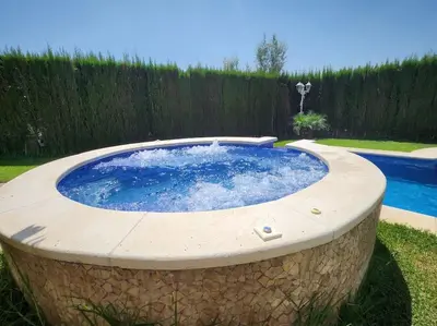 a large circular pool with a stone wall around it at Casa Villa Molins in Valencia