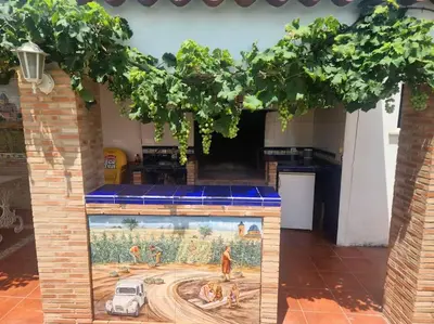 a building with a painting of people in a field at Casa Villa Molins in Valencia