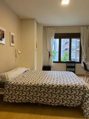 a bedroom with a large bed and a window at Apartamento junto Mercado Central Valencia in Valencia