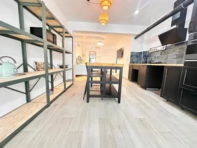 a kitchen with a wooden table and a counter top at Alberola Industrial Style in Valencia