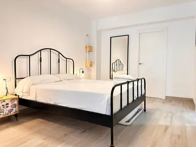 a bedroom with a large bed and a mirror at Alberola Industrial Style in Valencia