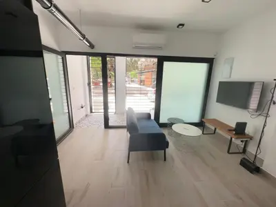 a living room with a couch and a tv at Alberola Industrial Style in Valencia