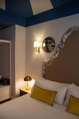 a bedroom with a white bed with a blue ceiling at Maison Primado B&B in Valencia