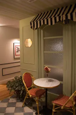 a table with two chairs and a table with a vase at Maison Primado B&B in Valencia