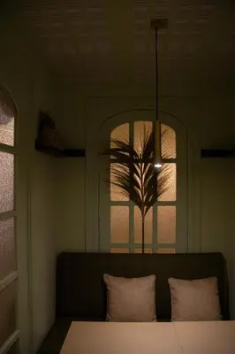 a room with a window with a table and two pillows at Maison Primado B&B in Valencia