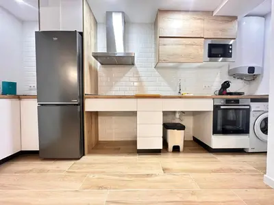 a kitchen with a stainless steel refrigerator and a dishwasher at Valencia & Suites Ayora in Valencia