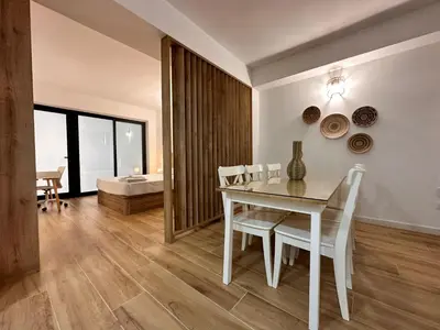 a dining room with a white table and chairs at Valencia & Suites Ayora in Valencia
