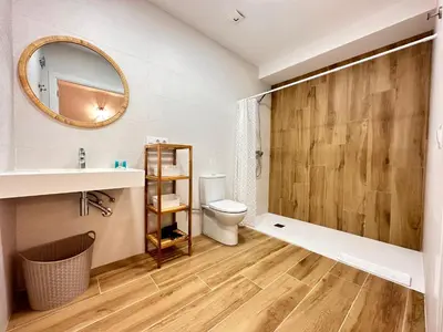 a bathroom with a toilet and a sink and a mirror at Valencia & Suites Ayora in Valencia
