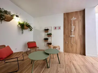a room with two tables and two chairs and a shower at Valencia & Suites Ayora in Valencia