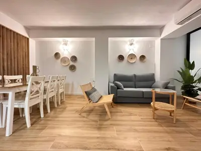 a living room with a couch and a table and chairs at Valencia & Suites Ayora in Valencia