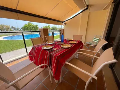 a dining room with a red table and chairs at Almenara, primera linea de playa VT-45077-CS in Almenara