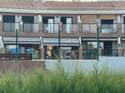 an apartment building with a fence in front of it at Almenara, primera linea de playa VT-45077-CS in Almenara