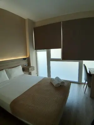 a bedroom with a bed and a desk and a window at OPTIMUS COMFORT Campoamor 101 in Valencia