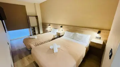 a room with two beds with a cross on them at OPTIMUS COMFORT Campoamor 101 in Valencia
