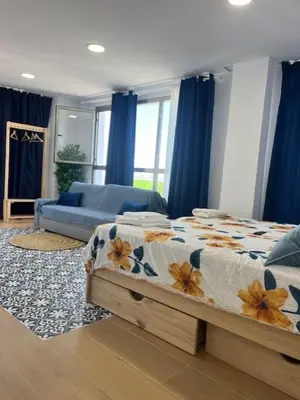 a bedroom with a bed and a couch at ALZIRA BONiTA LES BARRAQUES LOFT in Alzira