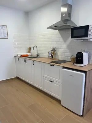 a kitchen with white cabinets and a sink at ALZIRA BONiTA LES BARRAQUES LOFT in Alzira