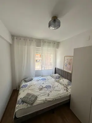a bed in a room with a window and a bedvisor at Seashell apartment in Cullera in Cullera