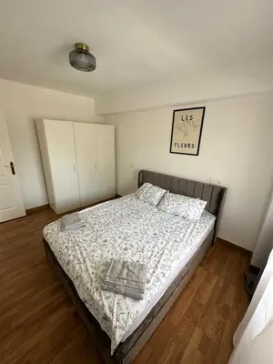 a bedroom with a bed and a clock on the wall at Seashell apartment in Cullera in Cullera