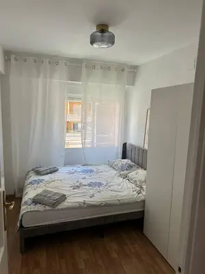 a bed in a room with a window and a bedvisor at Seashell apartment in Cullera in Cullera