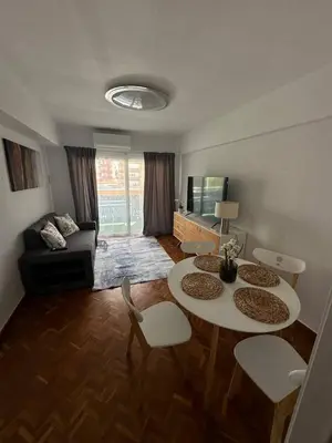 a living room with two tables and a couch at Seashell apartment in Cullera in Cullera