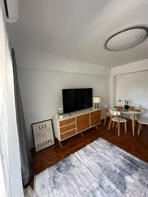 a living room with a flat screen tv and a table at Seashell apartment in Cullera in Cullera