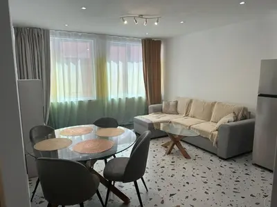 a living room with a couch and a table and chairs at Del Mar 1A - New Beach First floor apartment in Puerto de Sagunto