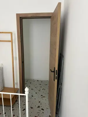 a wooden door in a room with a mirror at Del Mar 1A - New Beach First floor apartment in Puerto de Sagunto