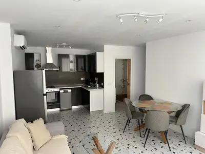 a living room and kitchen with a table and chairs at Del Mar 1A - New Beach First floor apartment in Puerto de Sagunto