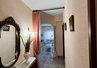 a hallway with a mirror and a table in a room at Apartamento en la Sierra Espadan in Artana