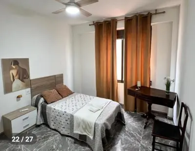 a bedroom with a bed and a desk and a piano at Apartamento en la Sierra Espadan in Artana