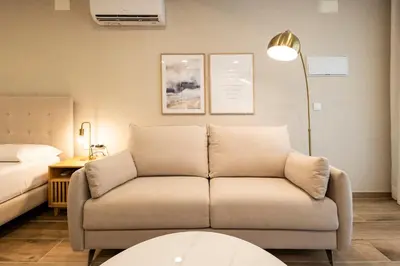 a living room with a couch and a bed at Cortes Suites by Concept Flats in Valencia